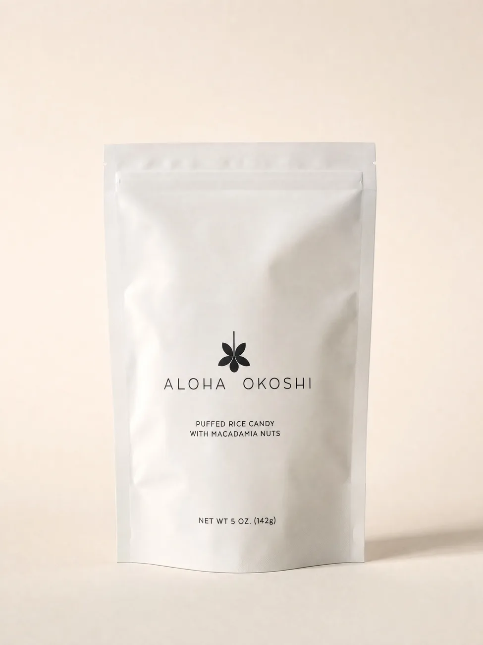 The Aloha Okoshi bag alone on warm off-white paper